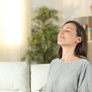 woman breathing clean air in home